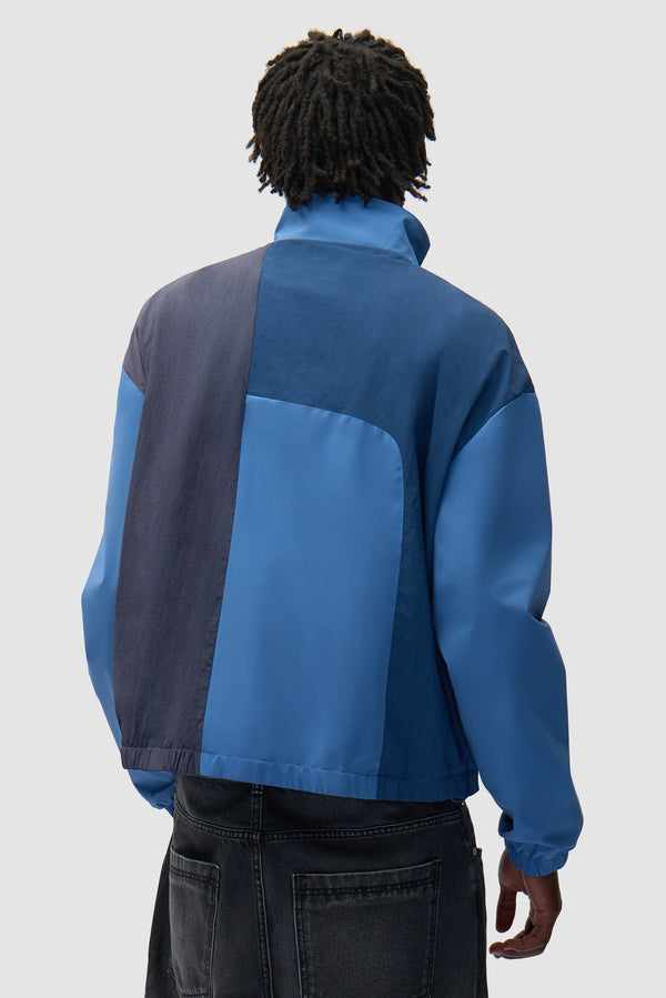 Curve Zipper Jacket in Blue worn by a model, half-body back view