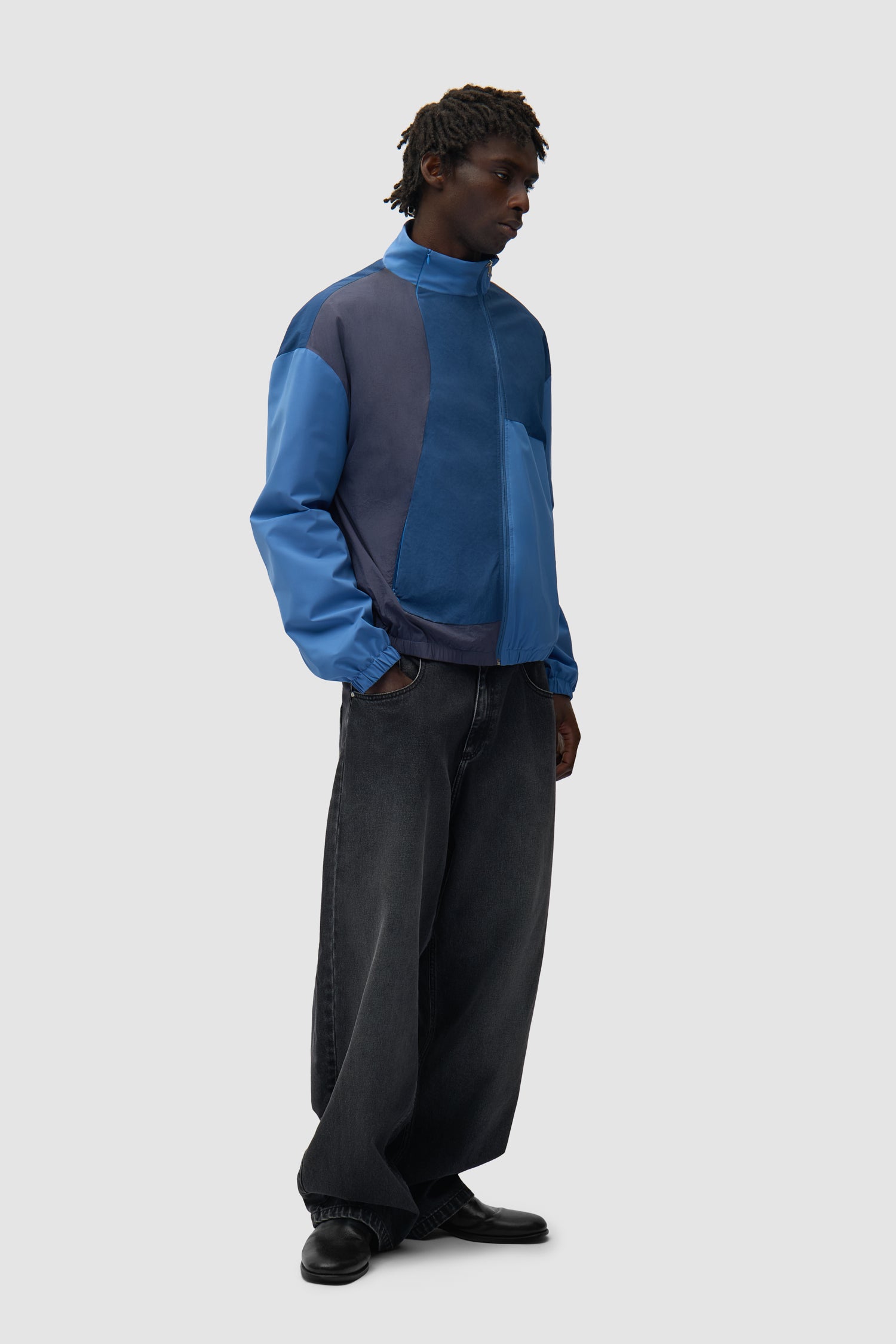 Curve Zipper Jacket in Blue worn by a model, full-body side view