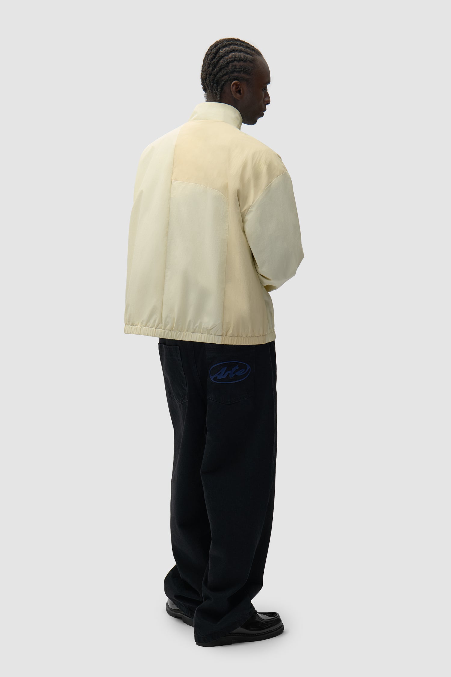 Curve Zipper Jacket in Cream worn by a model, full-body back view