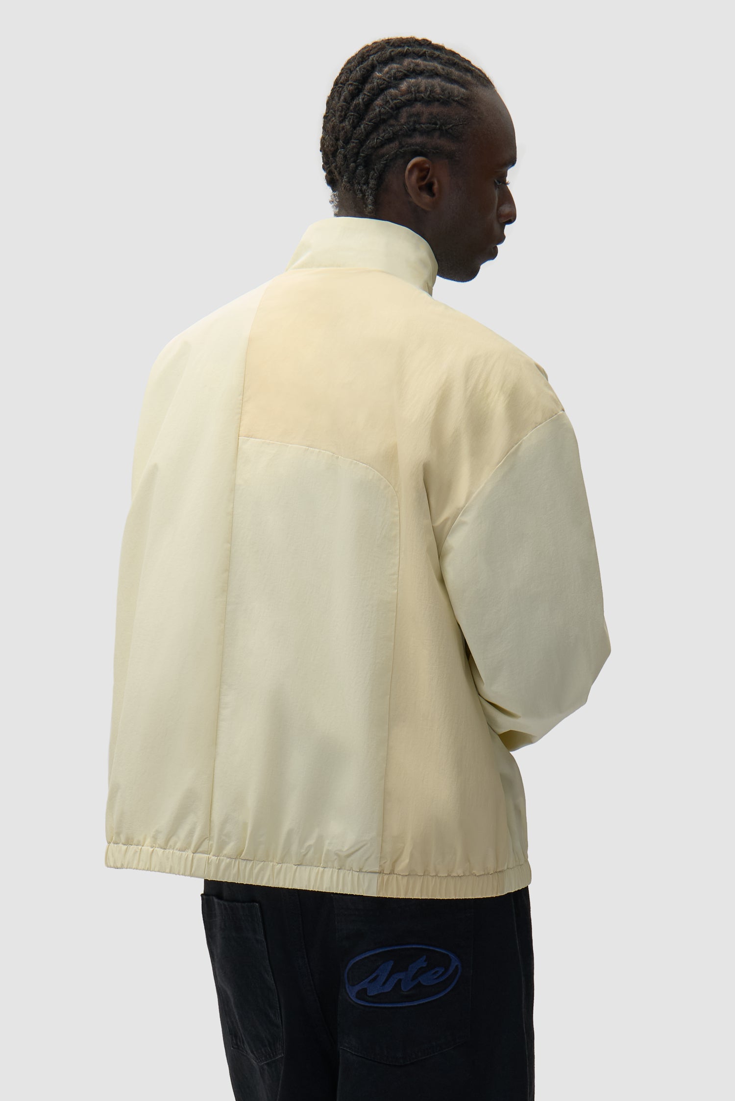 Curve Zipper Jacket in Cream worn by a model, half-body back view