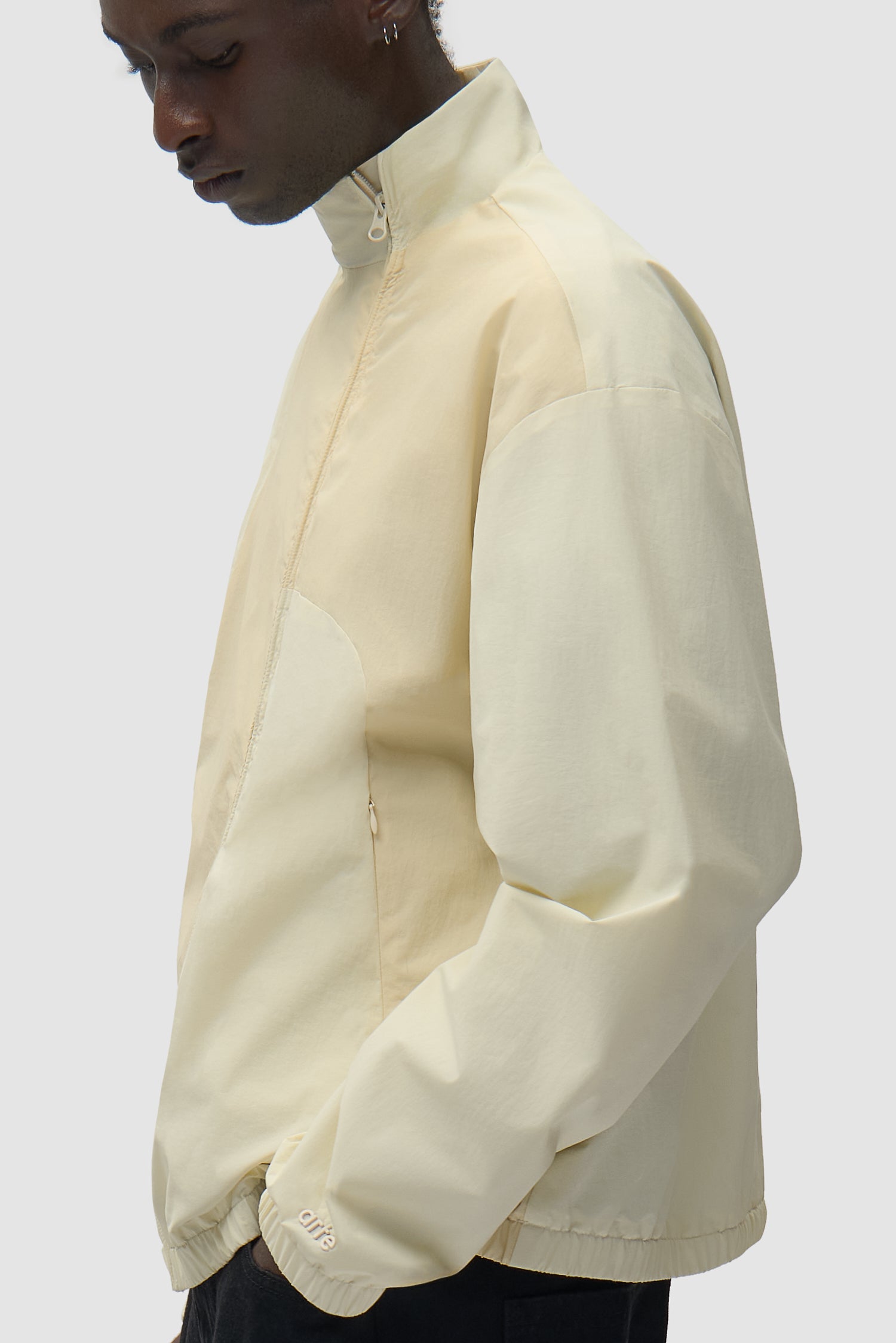 Curve Zipper Jacket in Cream worn by a model, half-body side view