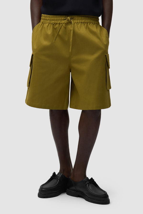 Linen Cargo Shorts in Green worn by a model, half-body front view
