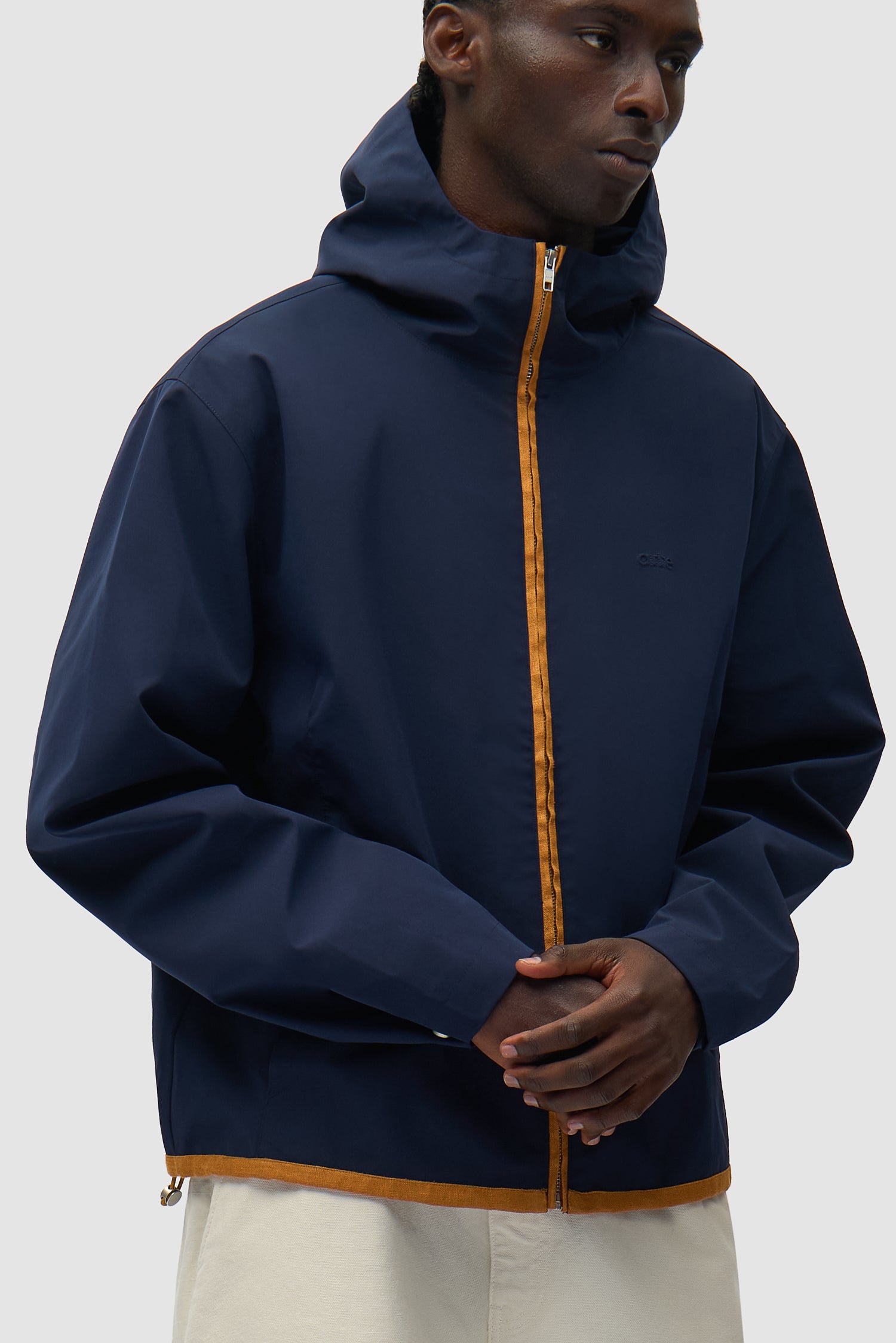 Linen Tape Hooded Jacket in Navy worn by a model, half-body side view
