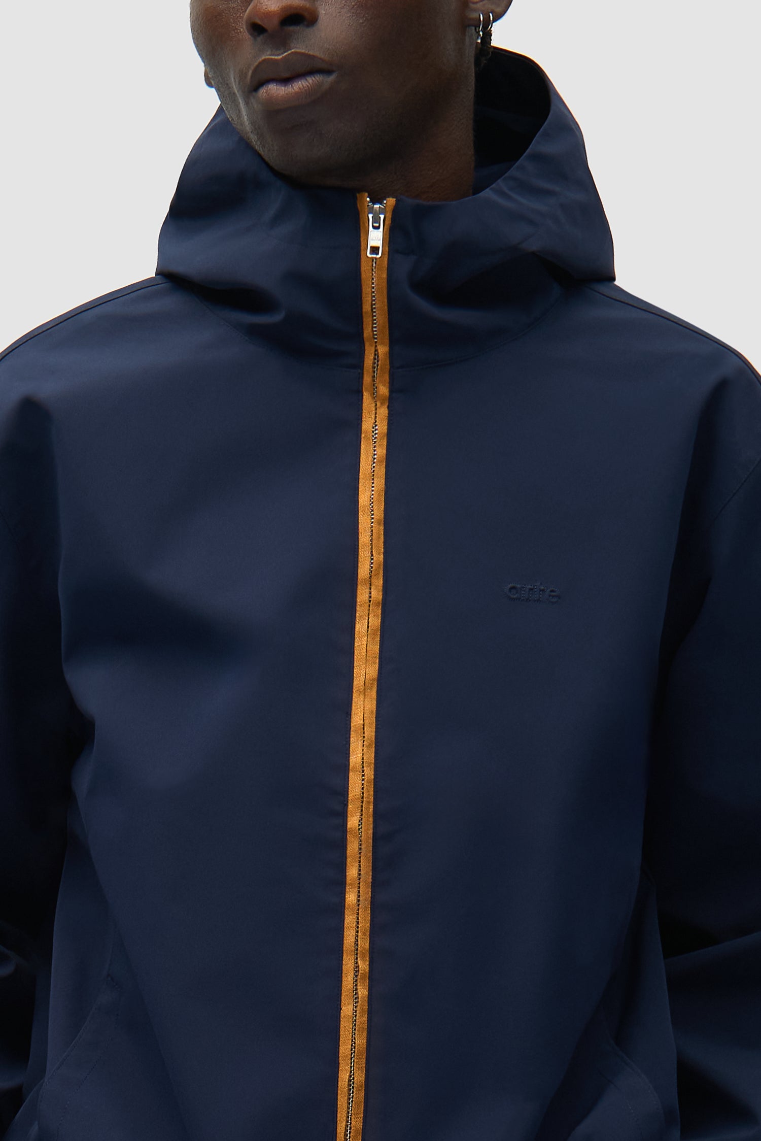 Detail view of Linen Tape Hooded Jacket in Navy, showing front zipper