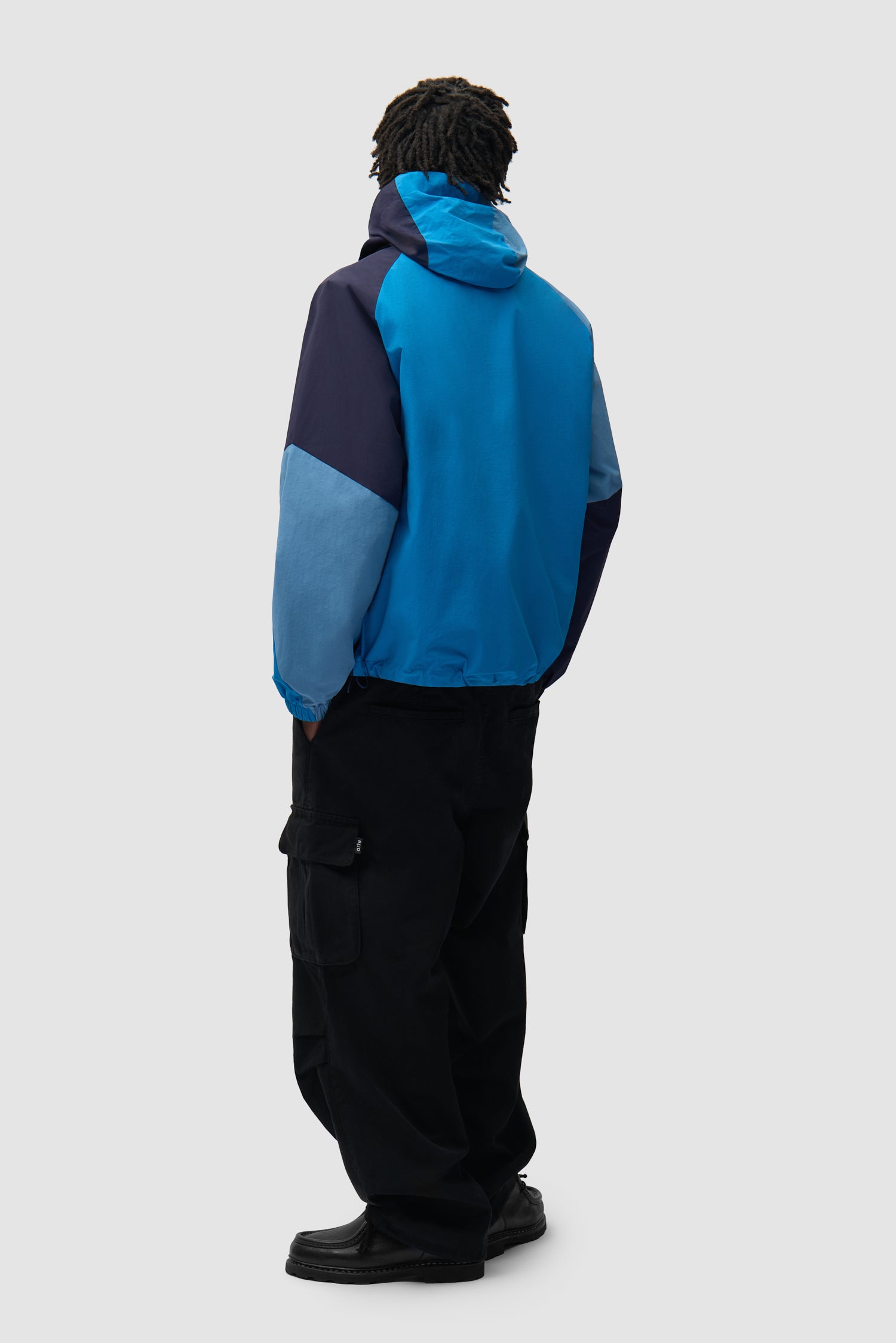 MultiColor Technical Jacket in Blue worn by a model, full-body back view
