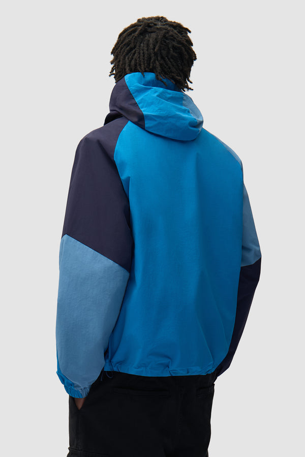 MultiColor Technical Jacket in Blue worn by a model, half-body back view