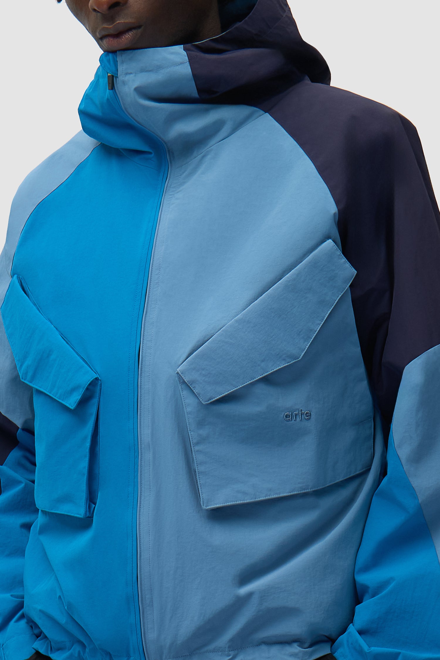 MultiColor Technical Jacket in Blue worn by a model, half-body side view