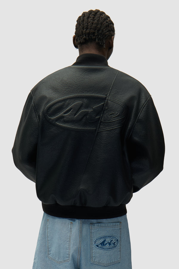Leather Varsity Jacket in Black worn by a model, half-body back view