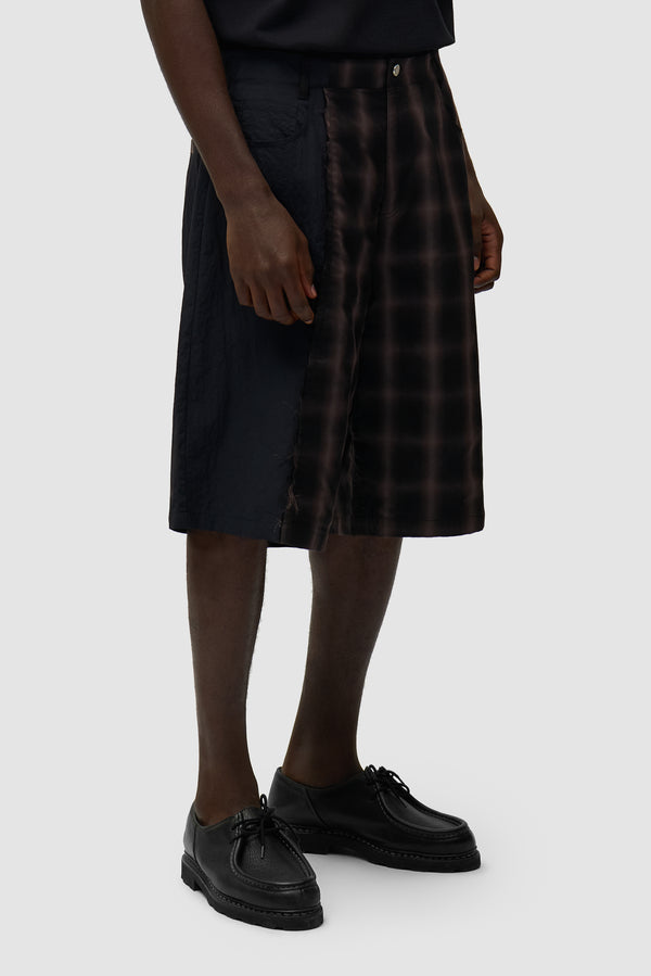 Plaided Shorts in Plaid worn by a model, half-body side view