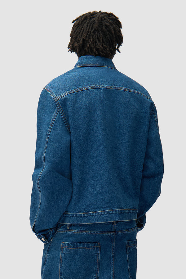 Fold Pocket Denim Jacket in Raw Denim worn by a model, half-body back view