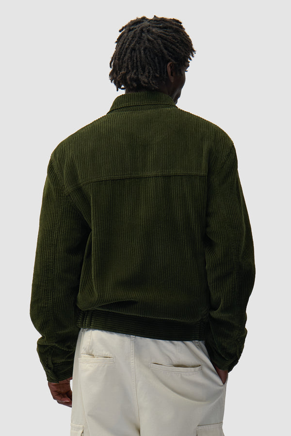 Corduroy Jacket in Green worn by a model, half-body back view