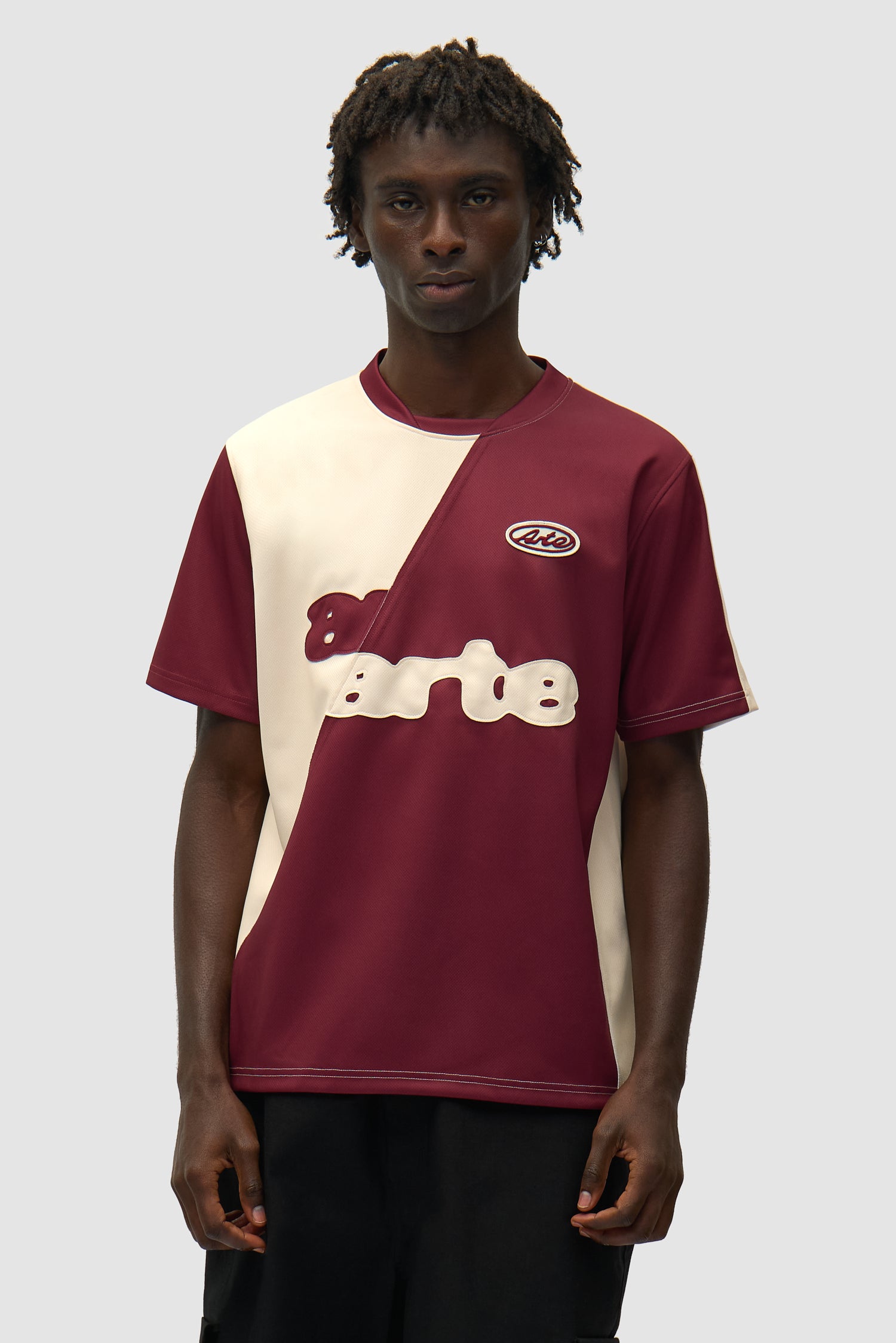 T-shirt de football bordeaux/crème porté par un mannequin, vue de face en demi-corps
