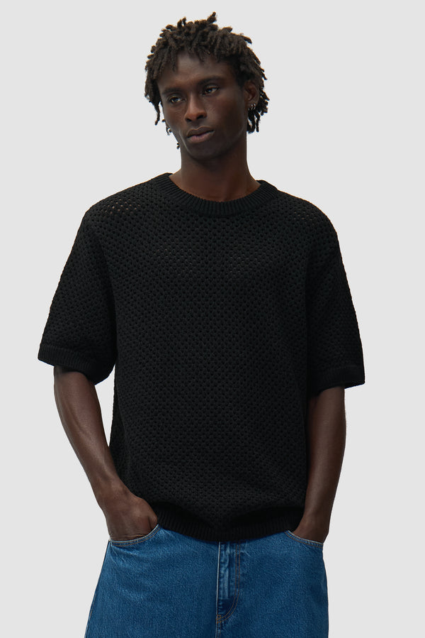 Crochet T-shirt in Black worn by a model, half-body front view