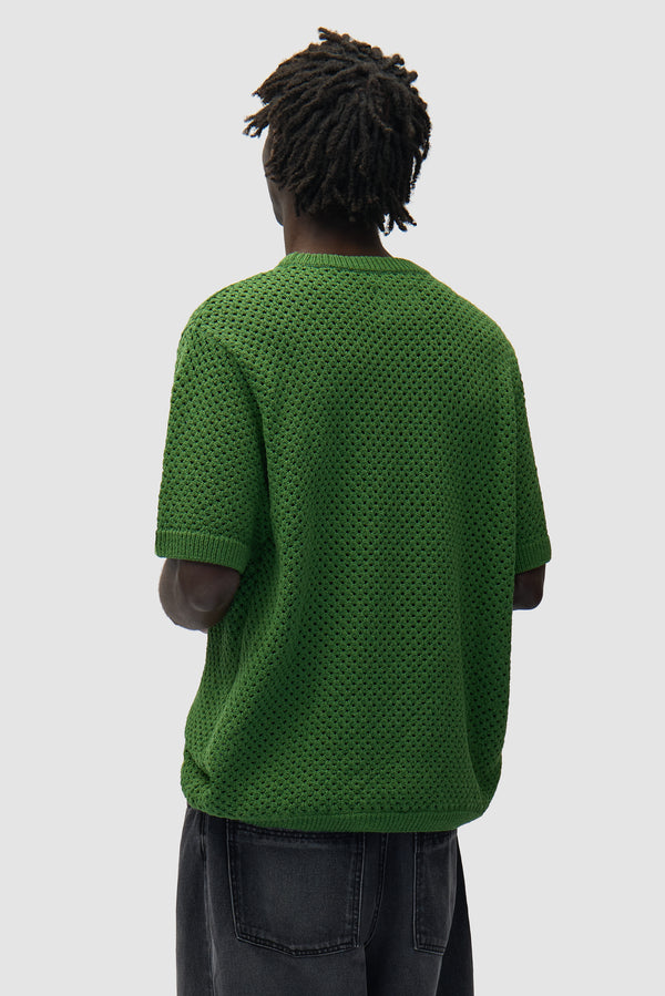Crochet T-shirt in Green worn by a model, half-body back view
