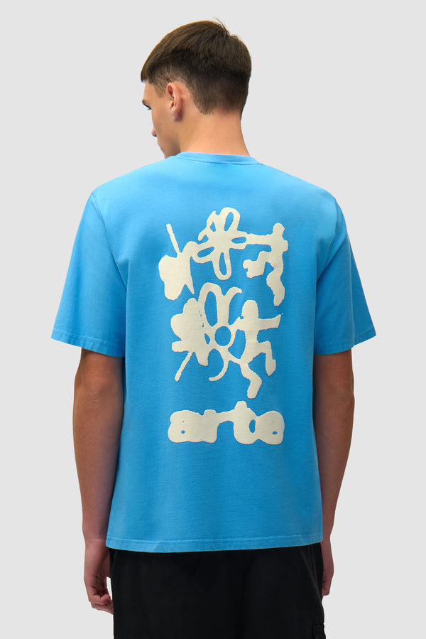 Blurry Back Print in Blue worn by a model, half-body back view