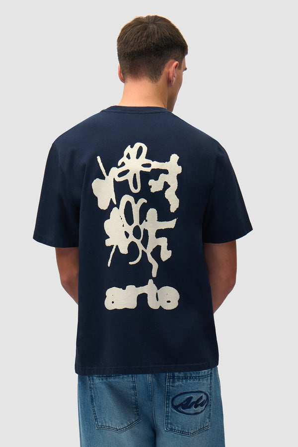Blurry Back Print in Navy worn by a model, half-body back view