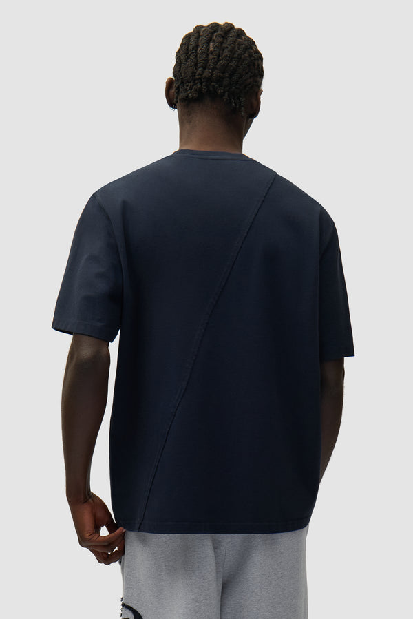 Circle Logo T-shirt in Navy worn by a model, half-body back view