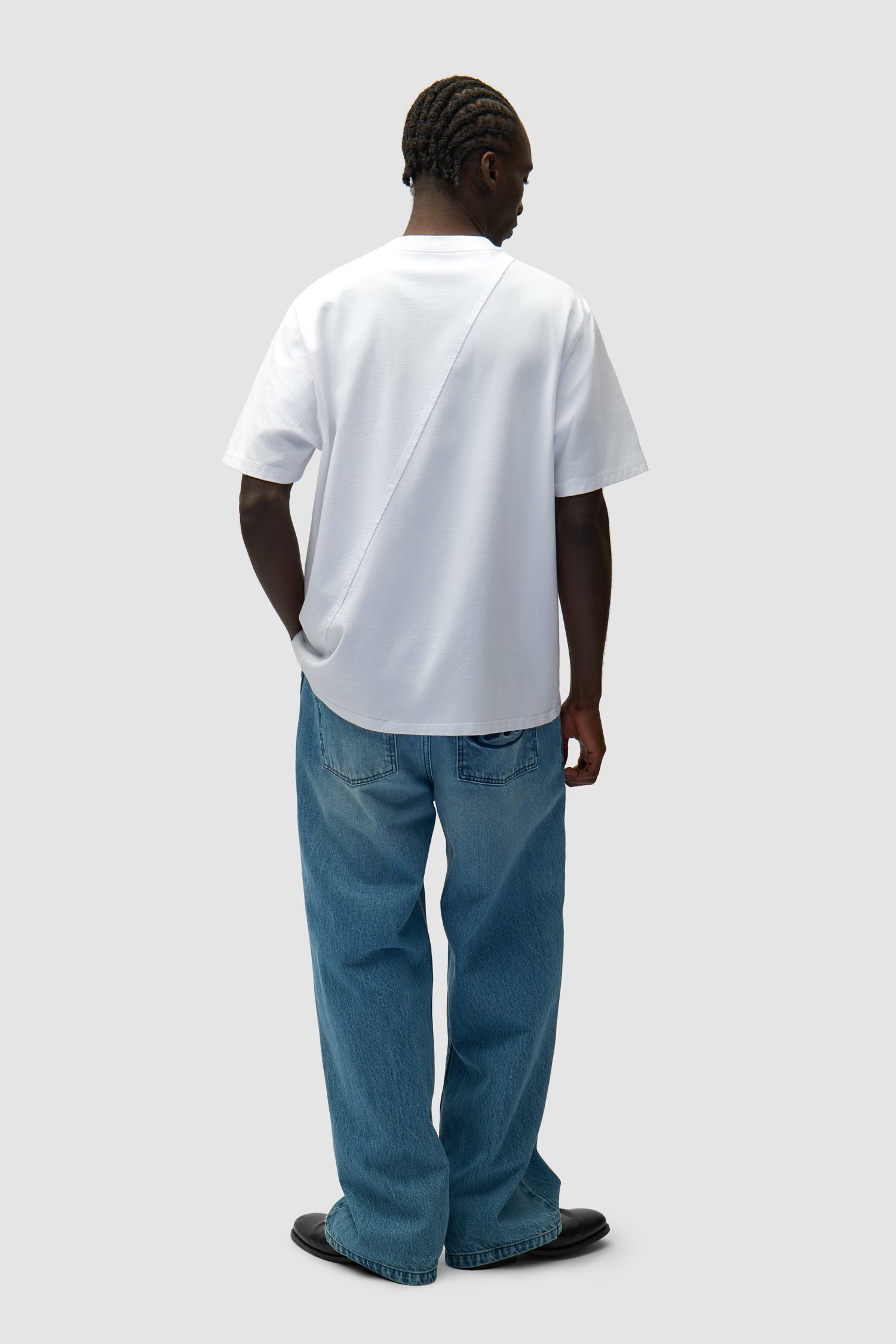 Circle Logo T-shirt in White worn by a model, full-body back view