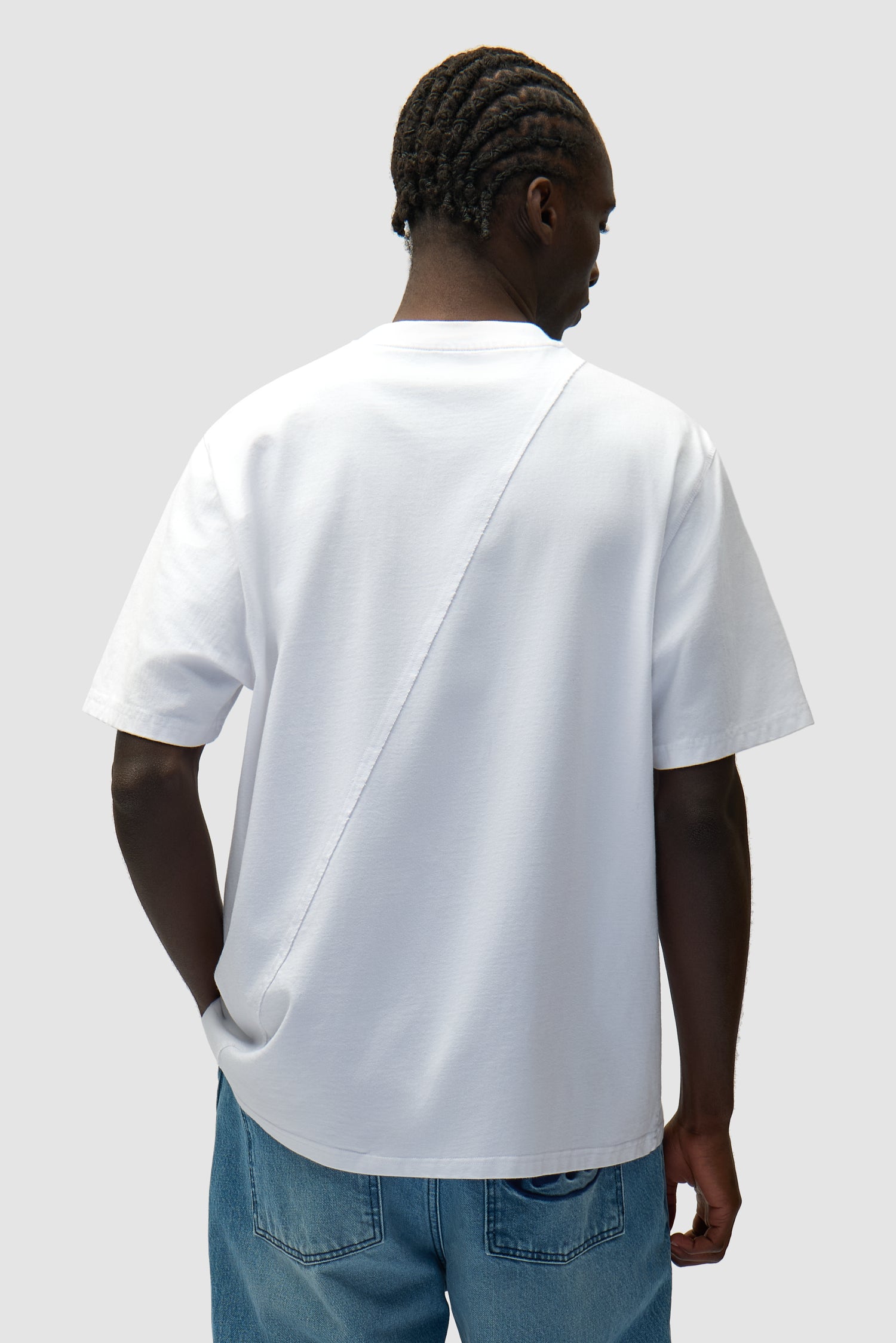 Circle Logo T-shirt in White worn by a model, half-body back view