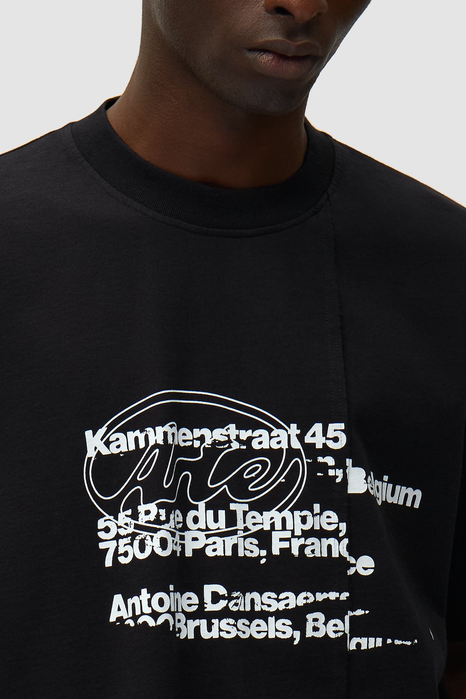 Detail view of Address T-shirt in Black, showing front logo
