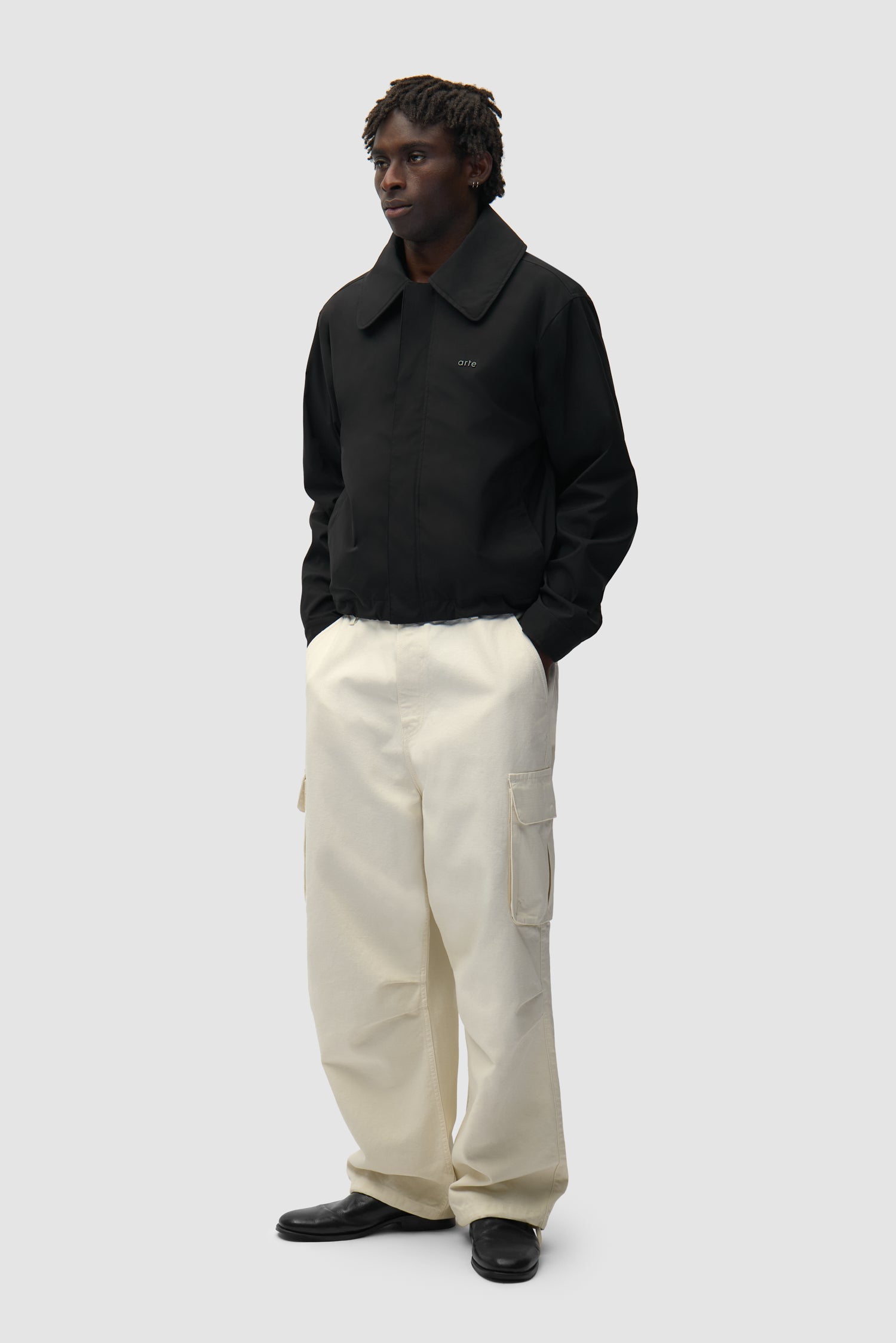 Big Collar Nylon Jacket in Black worn by a model, full-body side view