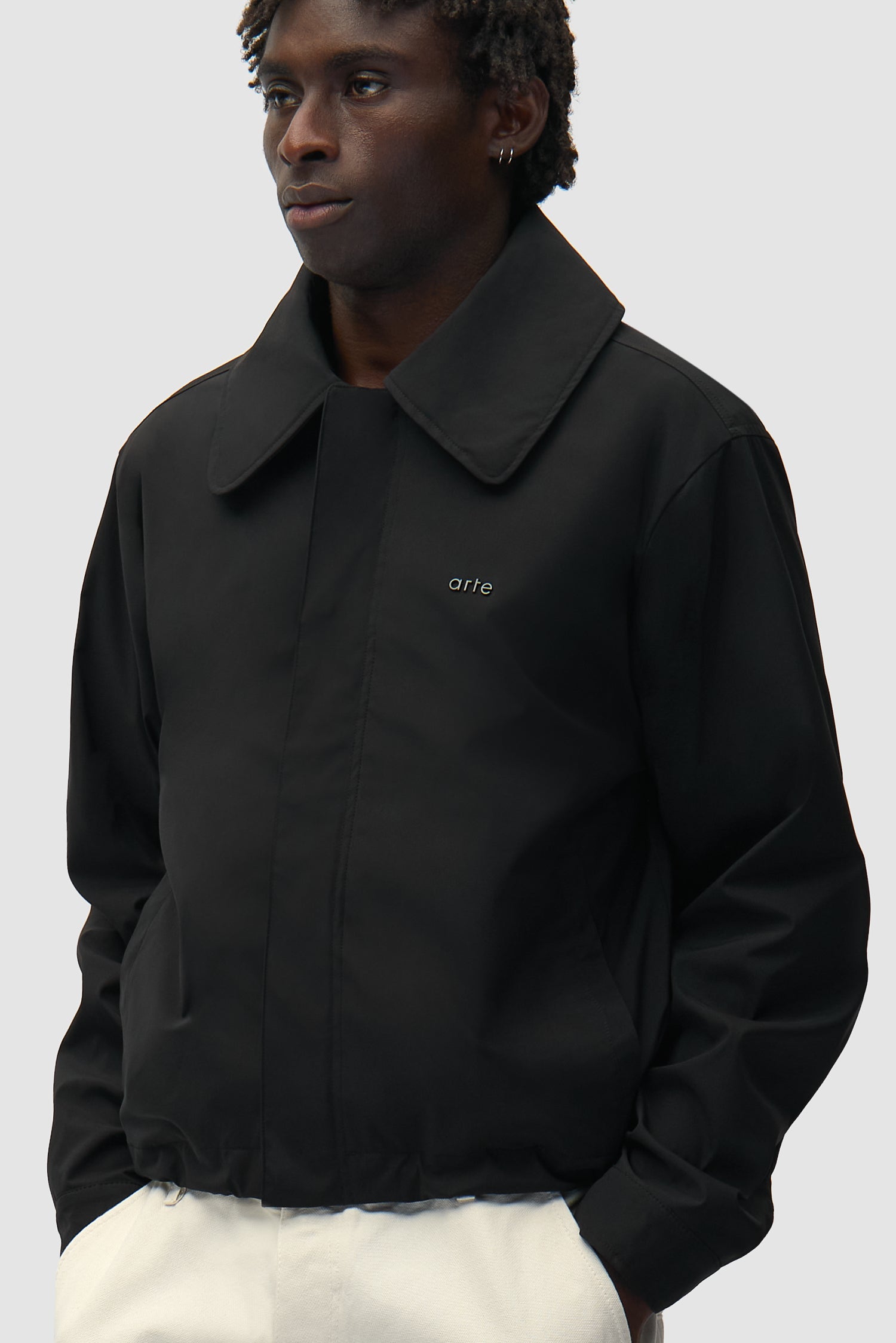 Big Collar Nylon Jacket in Black worn by a model, half-body side view