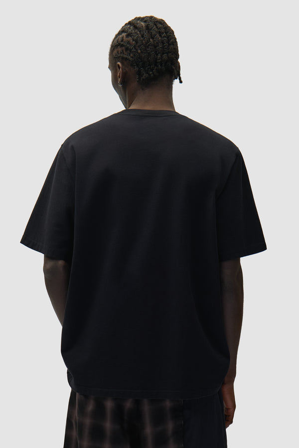Heart Logo T-shirt in Black worn by a model, half-body back view