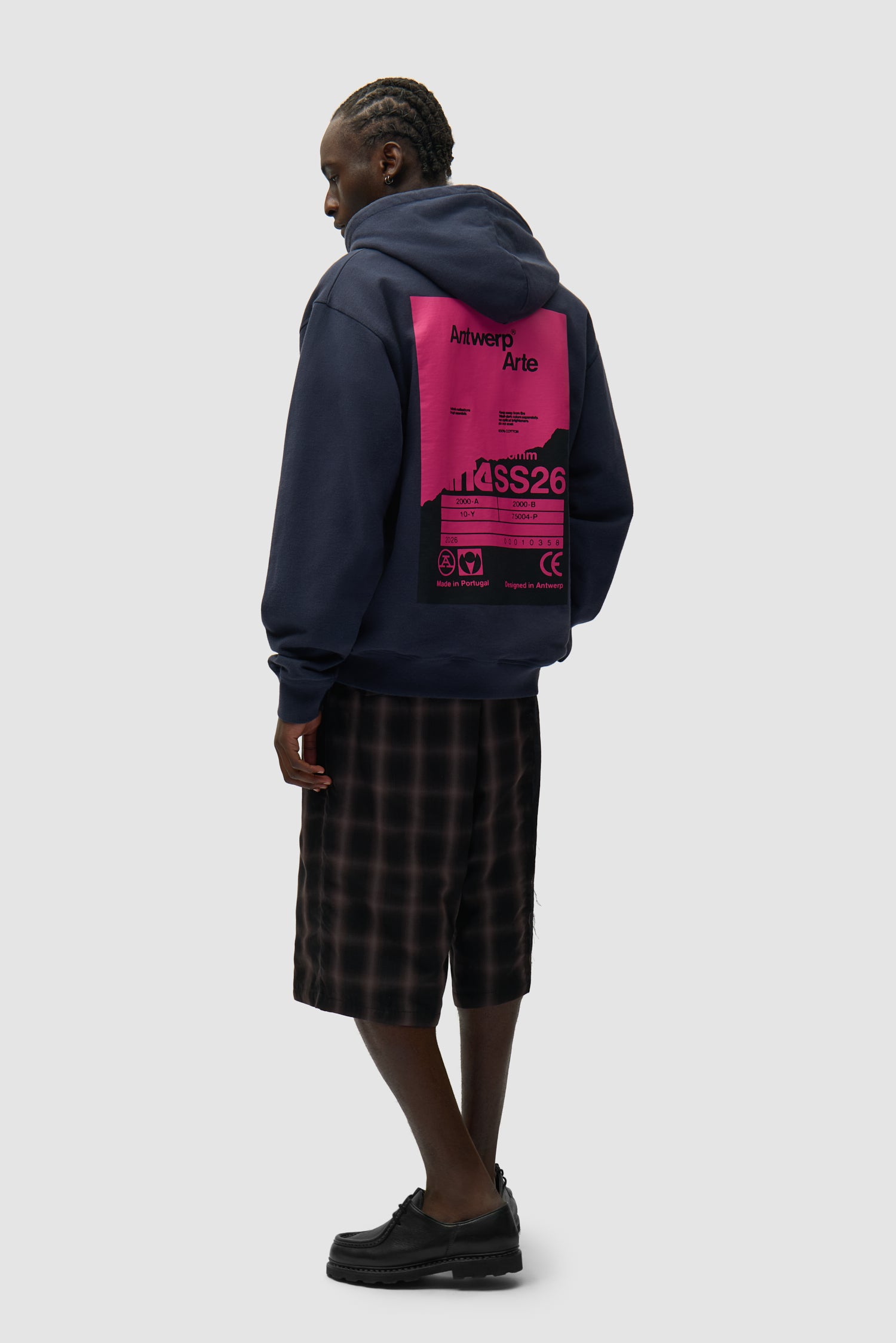 Back Poster Hoodie in Navy worn by a model, full-body side view