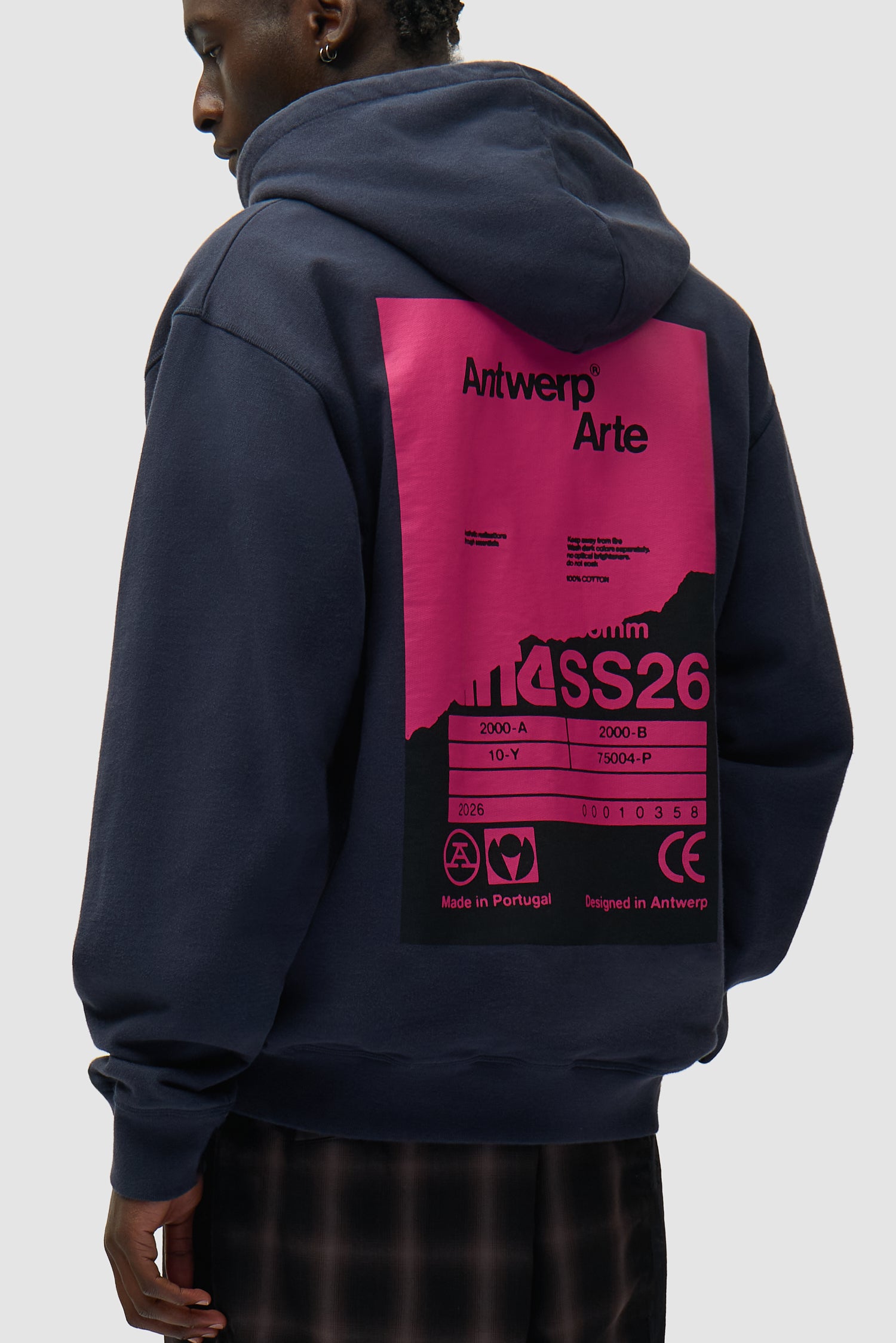 Back Poster Hoodie in Navy worn by a model, half-body side view