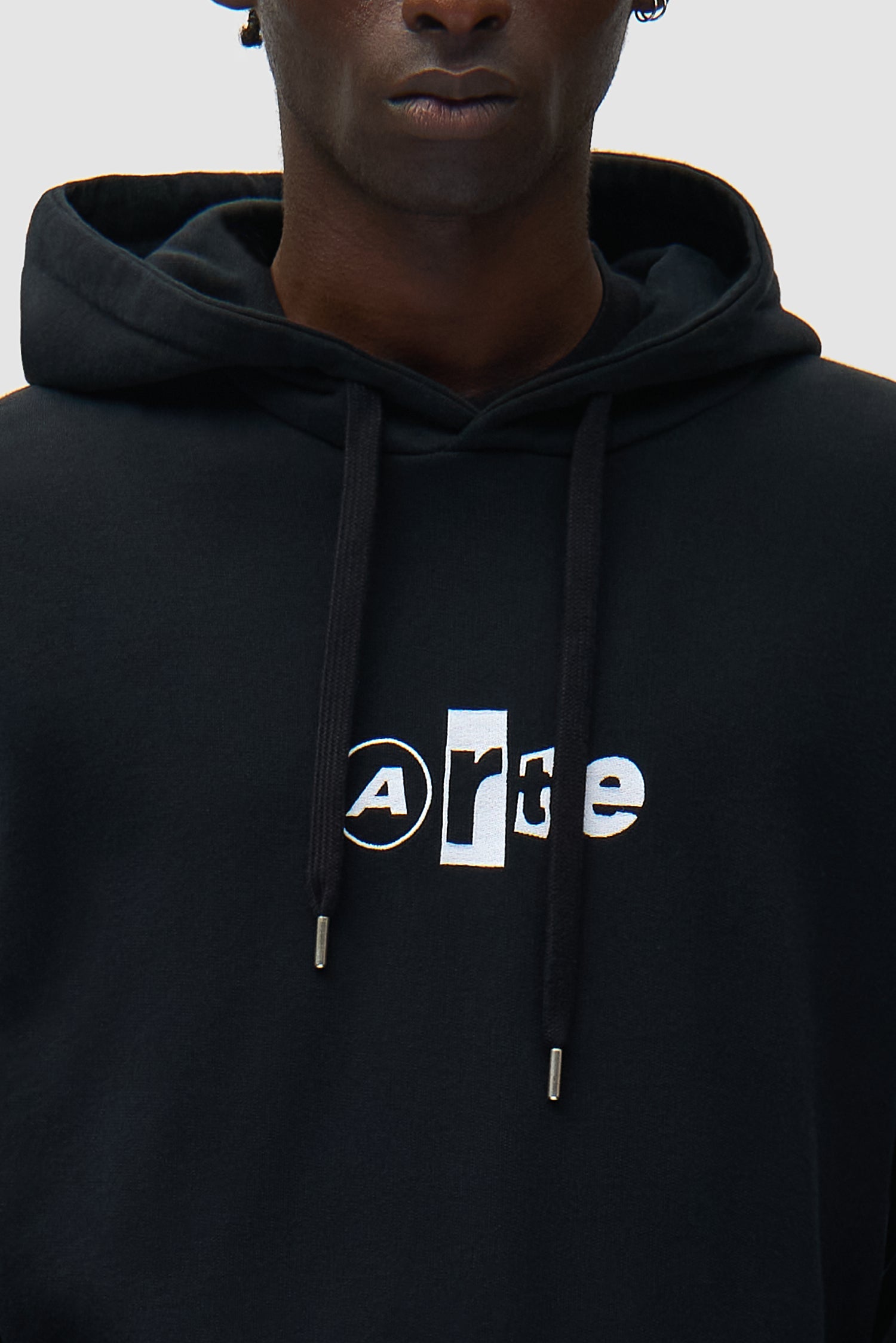 Detail view of Collage Logo Hoodie in Black, showing logo