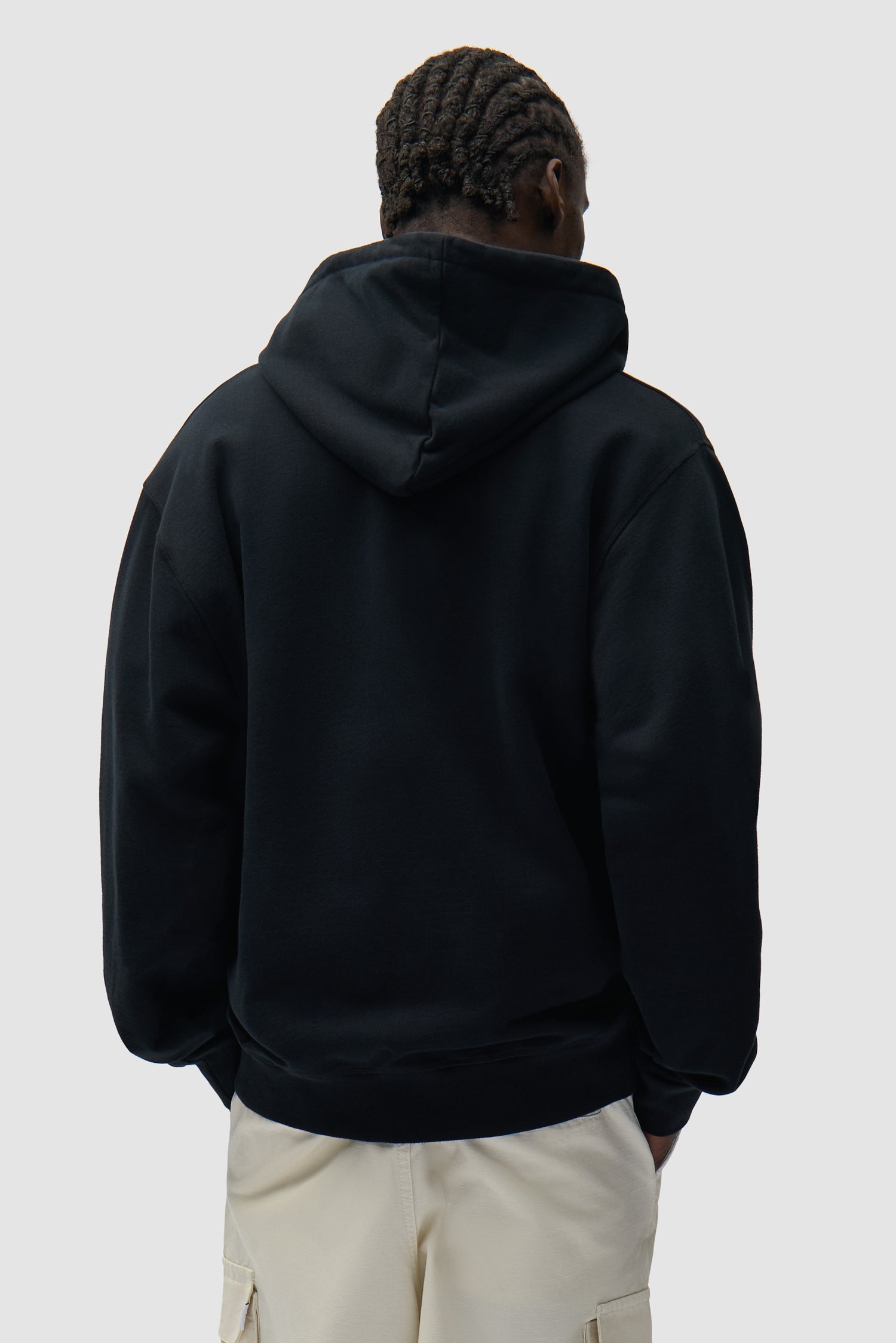 Collage Logo Hoodie in Black worn by a model, half-body back view