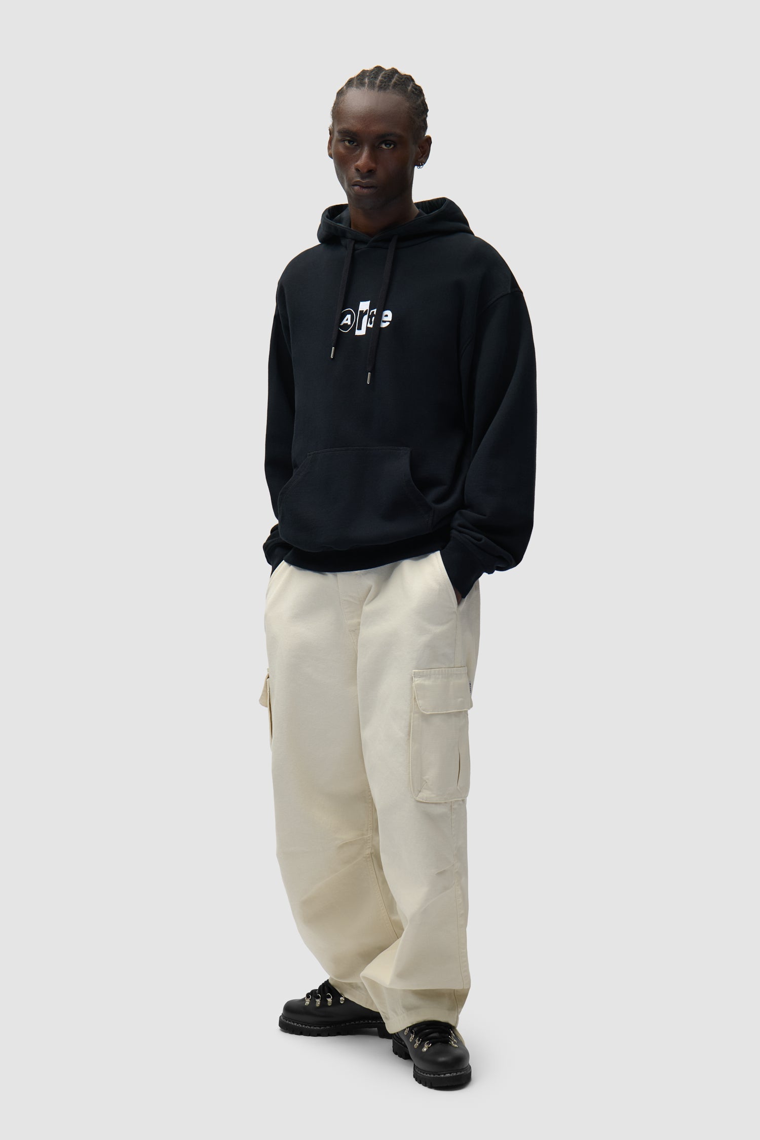 Collage Logo Hoodie in Black worn by a model, full-body side view