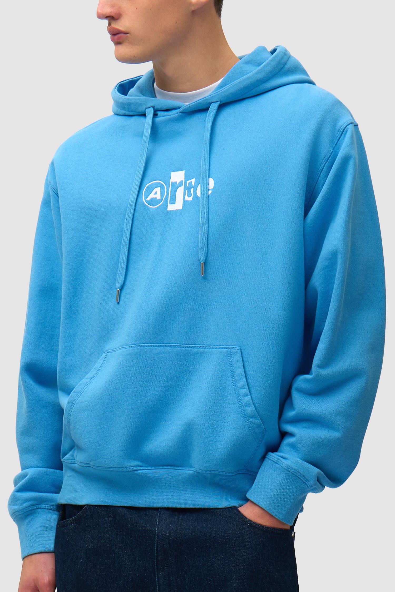 Collage Logo Hoodie in Blue worn by a model, half-body side view