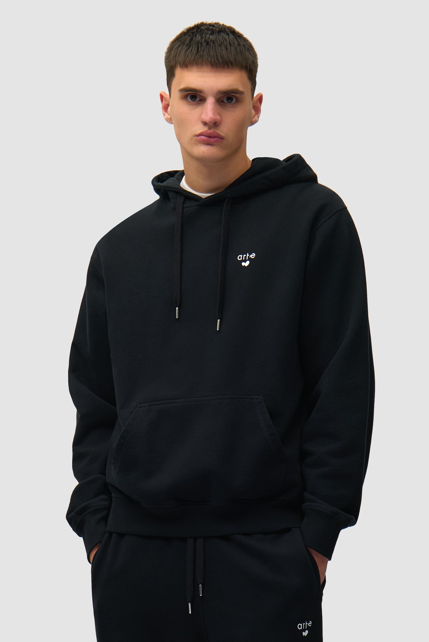 Heart Logo Hoodie in Black worn by a model, half-body front view