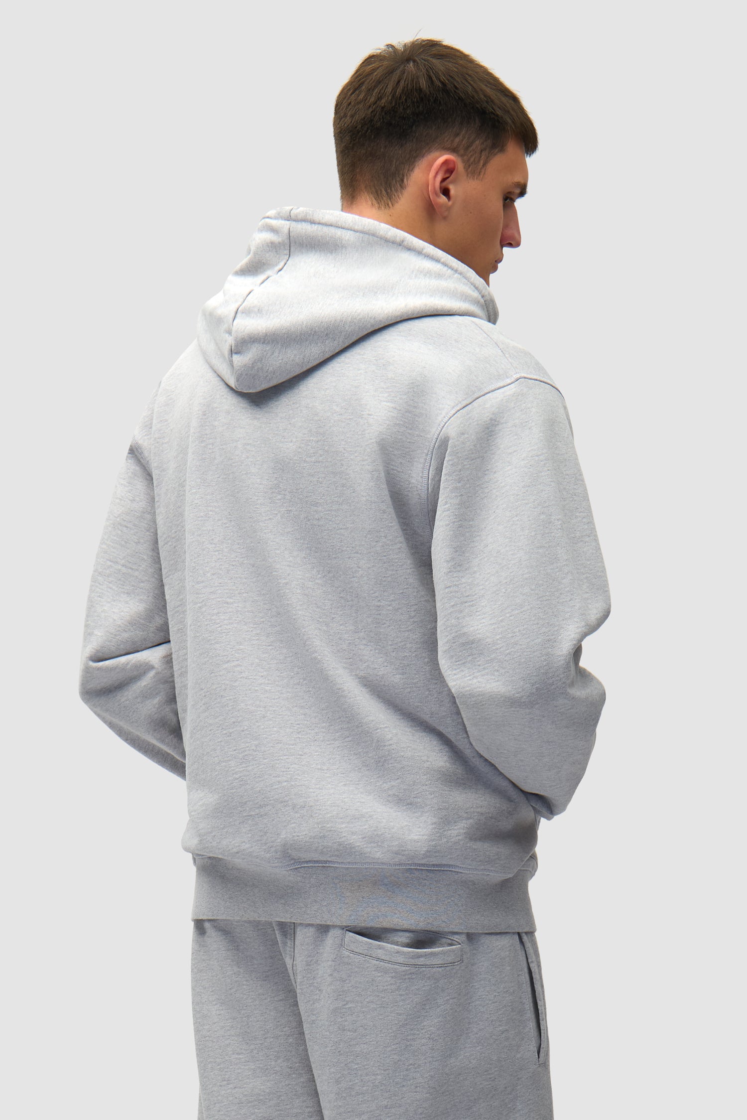 Heart Logo Hoodie in Grey worn by a model, half-body back view