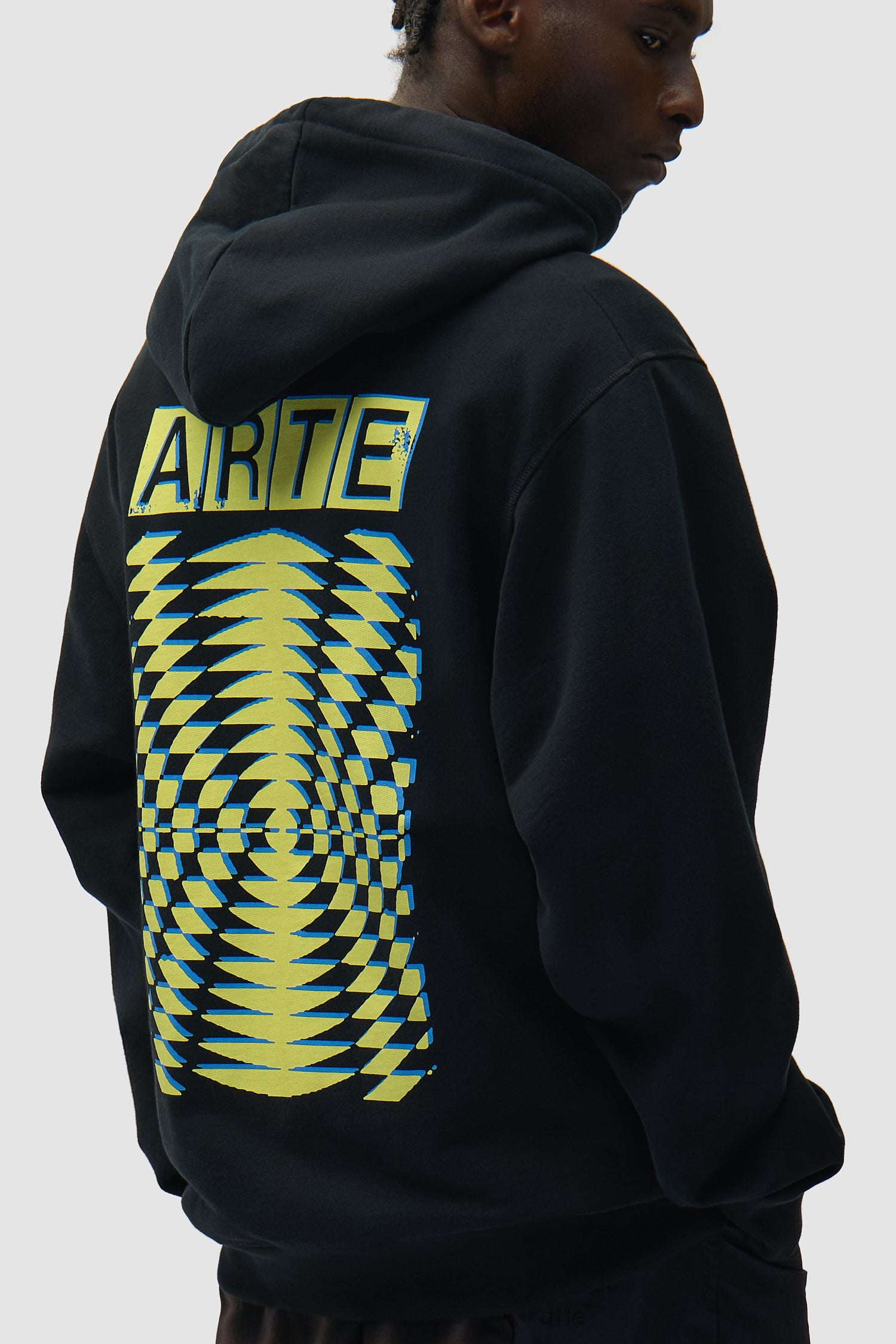 Back Abstract Hoodie in Black worn by a model, half-body side view