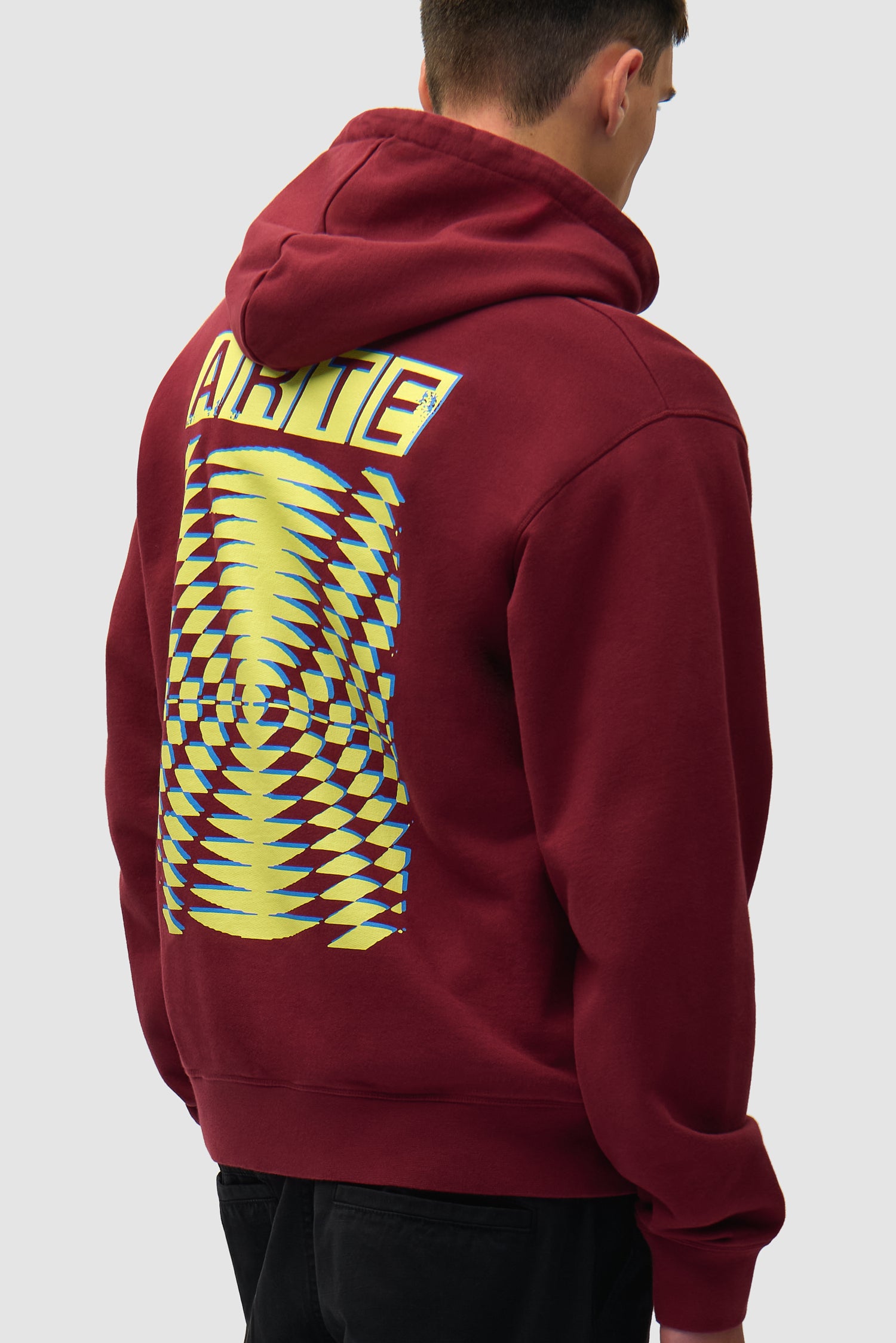 Back Abstract Hoodie in Bordeaux worn by a model, half-body side view