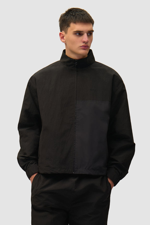 Squared Track Jacket in Black worn by a model, half-body front view