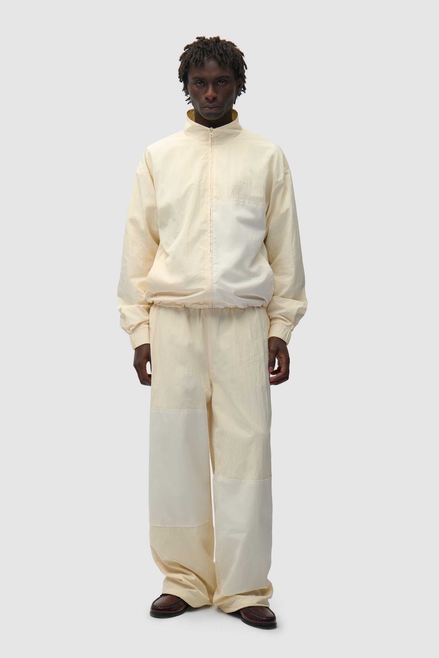 Squared Track Jacket in Cream worn by a model, full-body front view