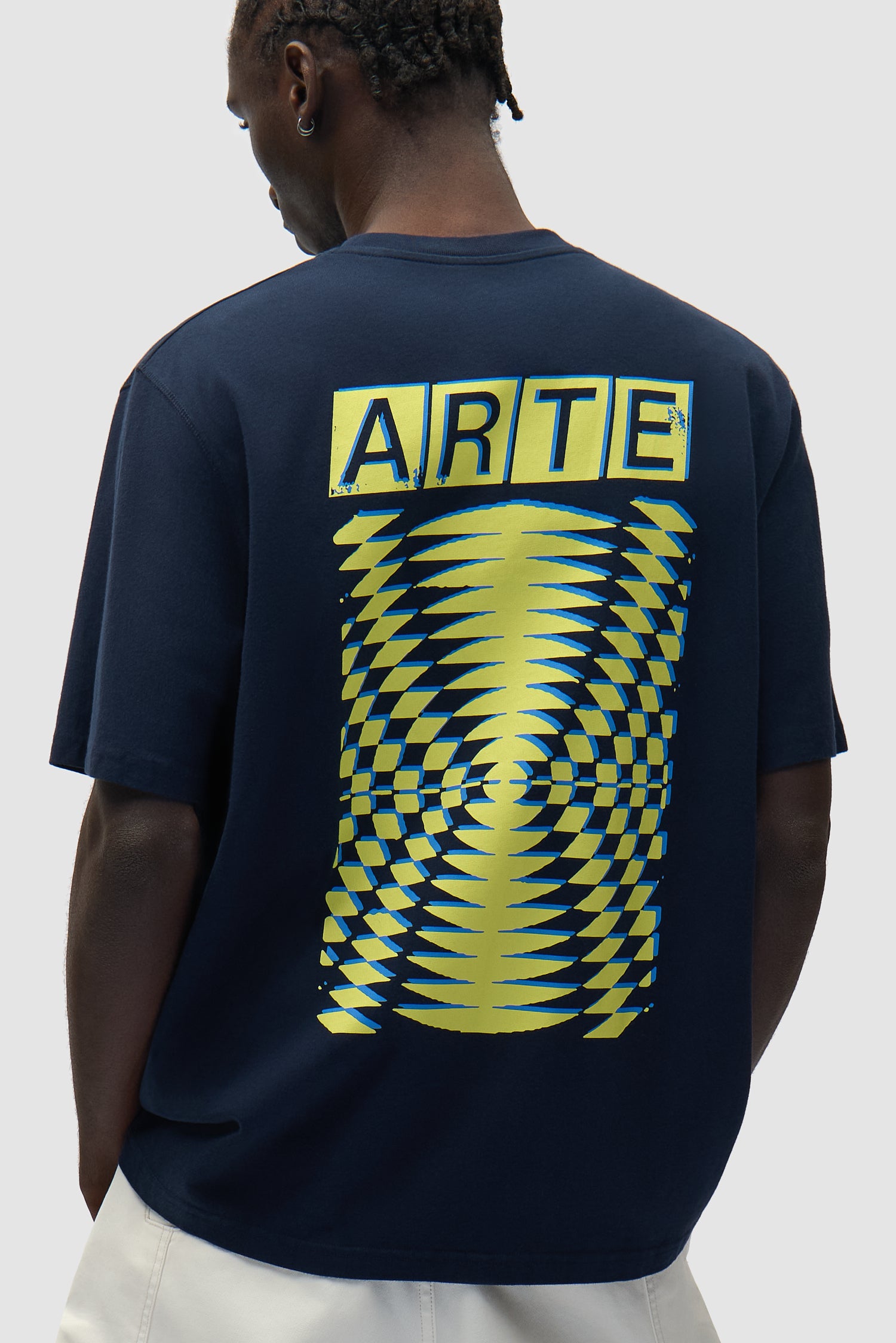 T-shirt à motif abstrait imprimé au dos, couleur bleu marine, porté par un mannequin, vue de profil à mi-corps.