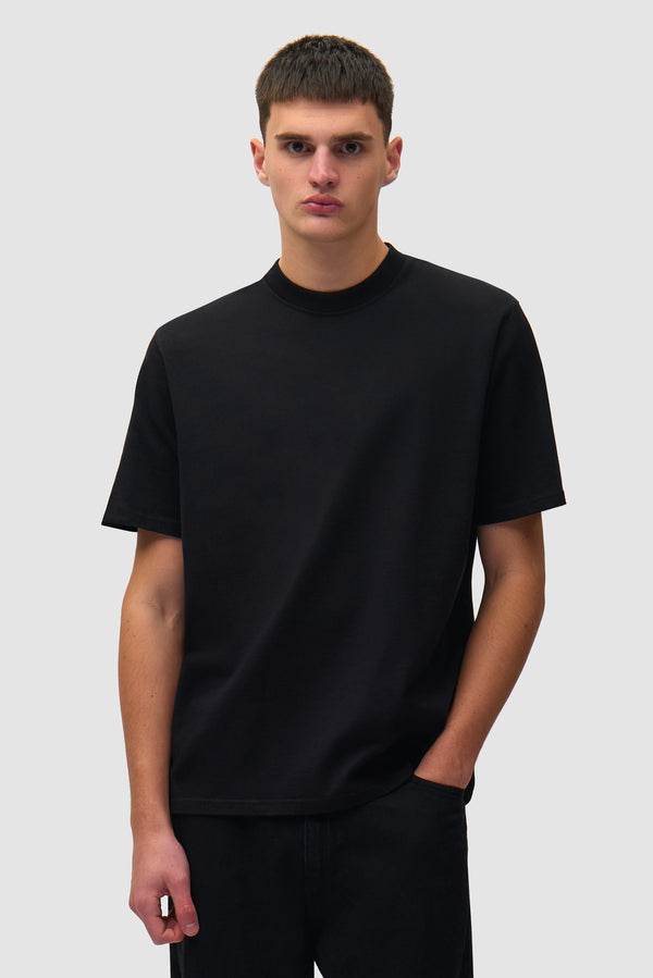 Big Logo Back T-shirt in Black worn by a model, half-body front view