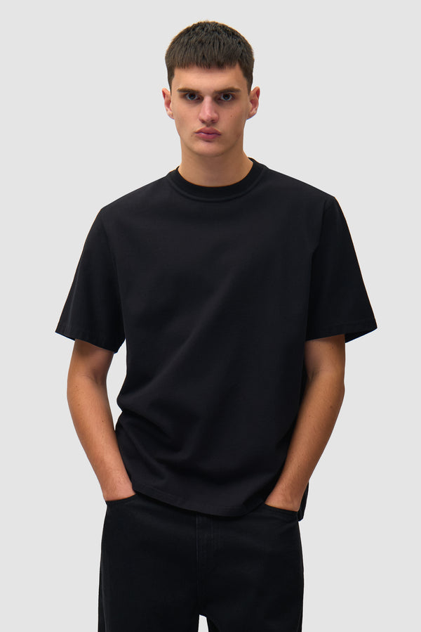 Faded Back Print T-shirt in Black worn by a model, half-body front view