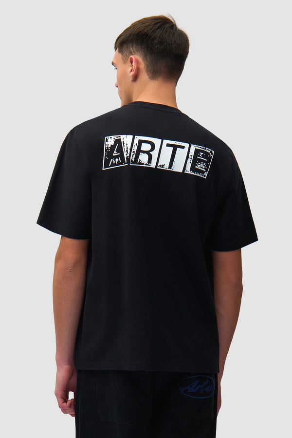Faded Back Print T-shirt in Black worn by a model, half-body back view