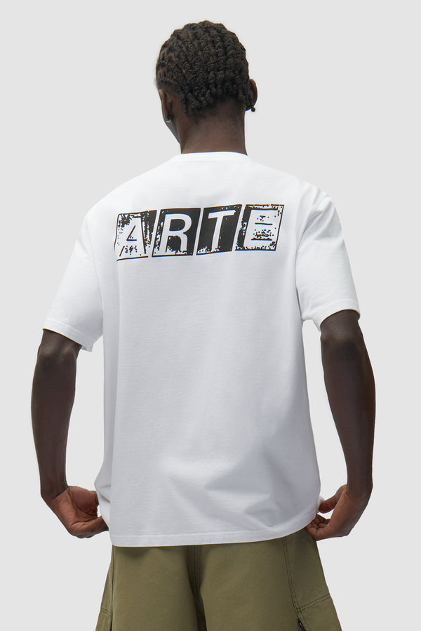Faded Back Print T-shirt in White worn by a model, half-body back view