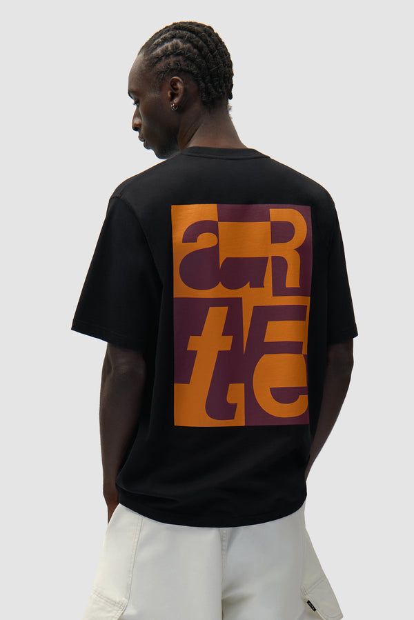 Back Graphic T-shirt in Black worn by a model, half-body back view