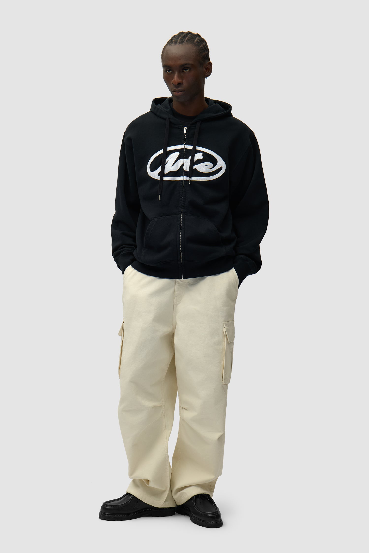 Circle Logo Zip Hoodie in Black worn by a model, full-body front view