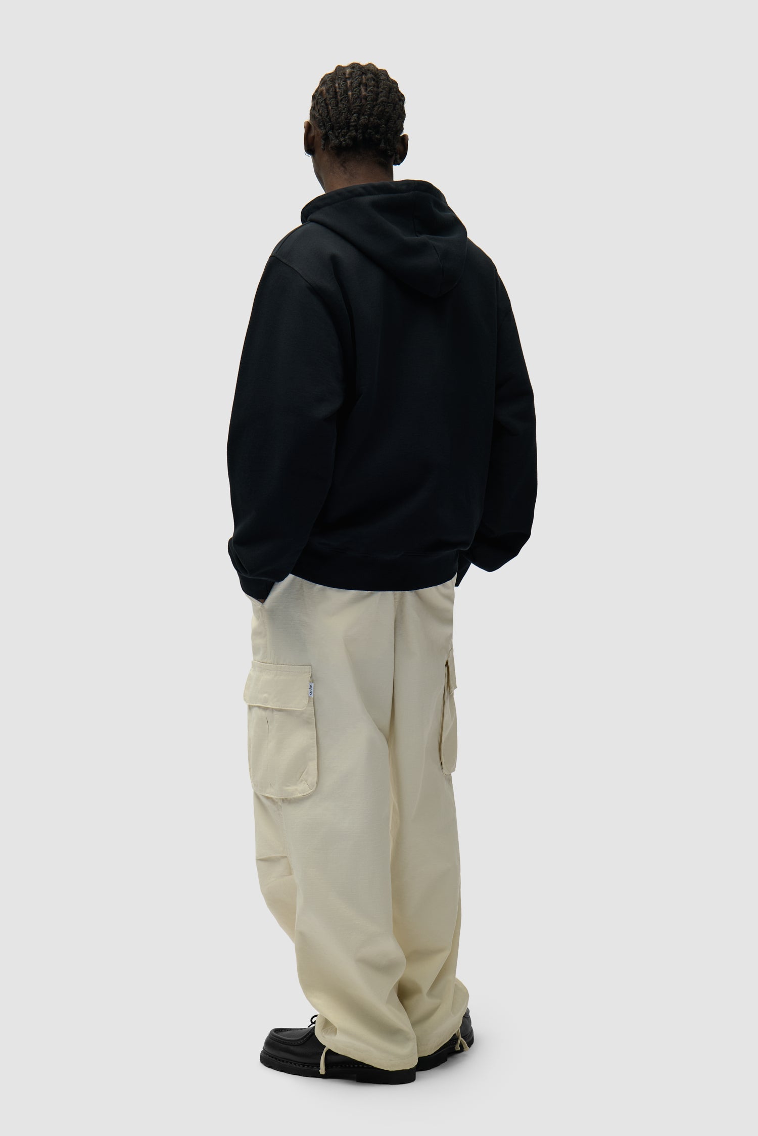 Circle Logo Zip Hoodie in Black worn by a model, full-body back view