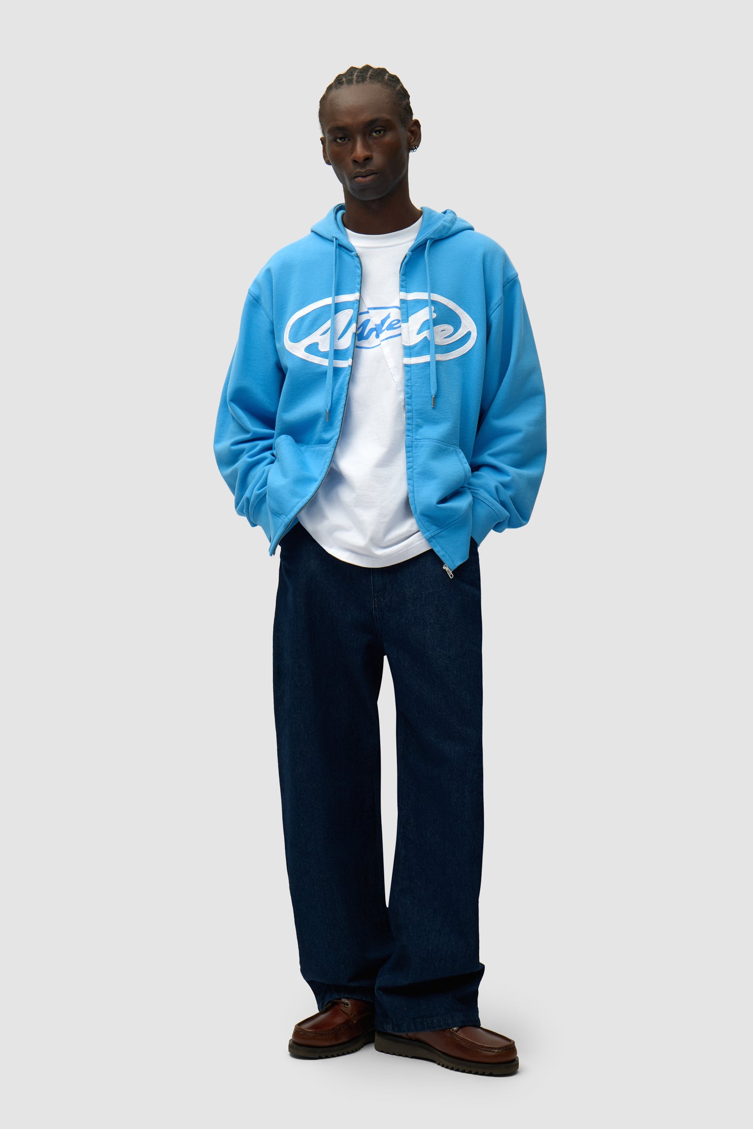 Circle Logo Zip Hoodie in Blue worn by a model, full-body side view