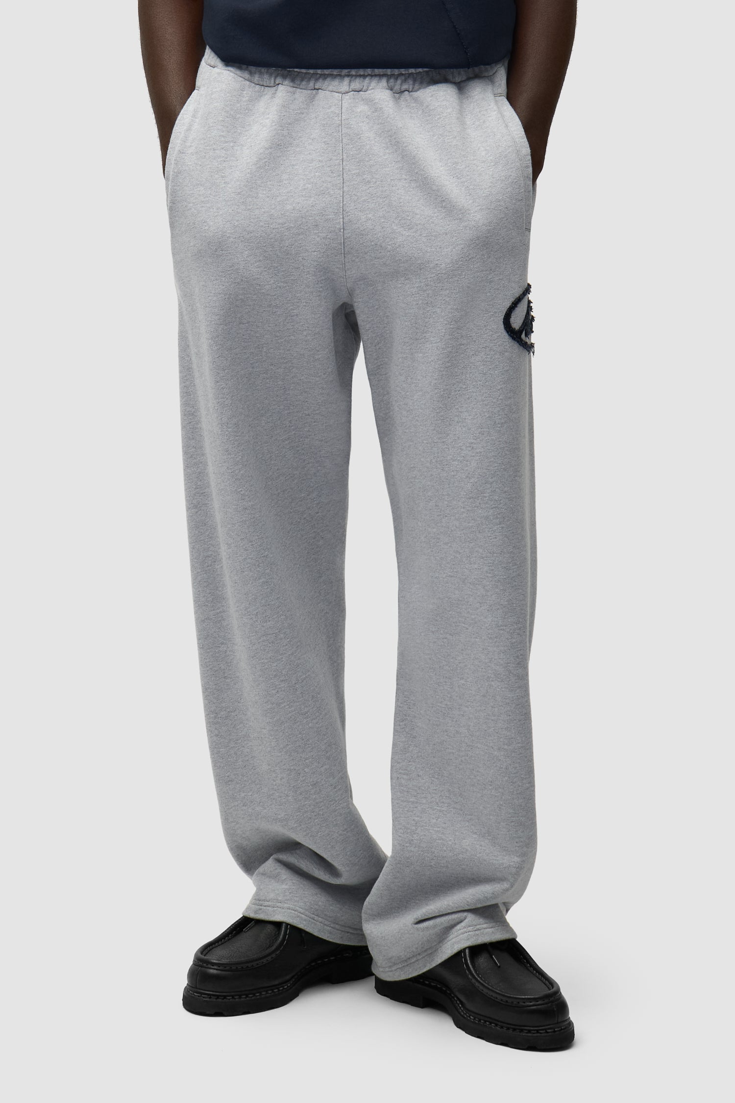 Circle Patch Logo Sweatpants in Grey worn by a model, half-body front view