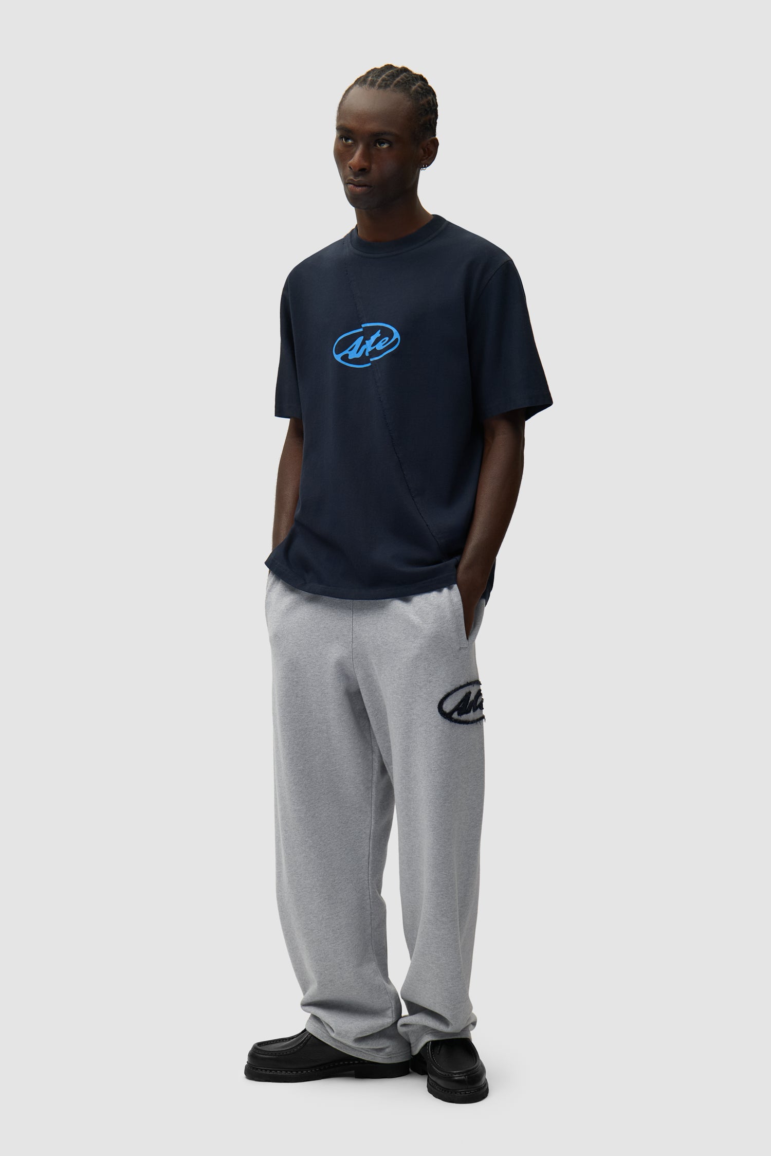 Circle Patch Logo Sweatpants in Grey worn by a model, full-body side view